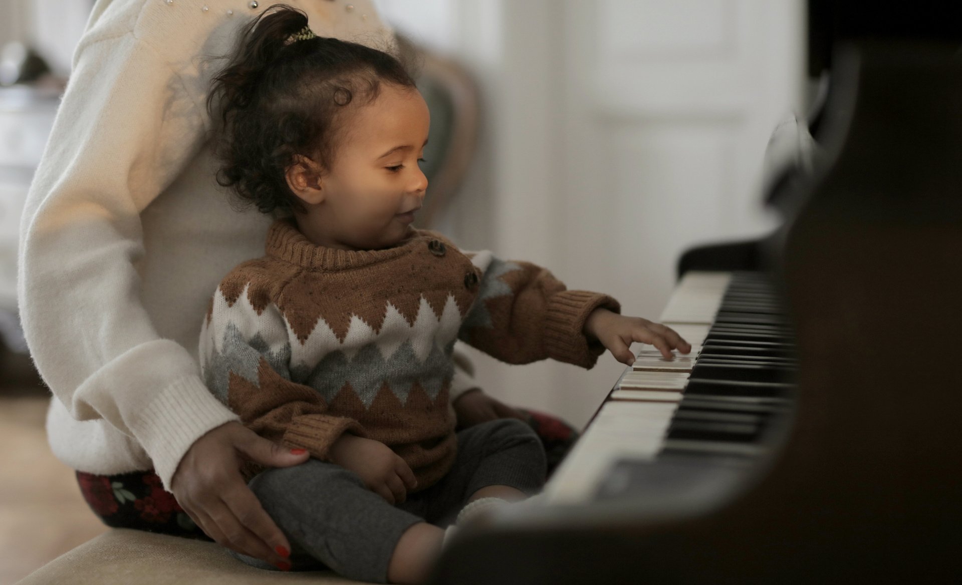 Girl in Brown Sweater Playing Piano